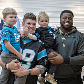 Kawann Short of the Carolina Panthers and Drs. Megan and Matt Lineberger in Charlotte, Huntersville, and Mooresville