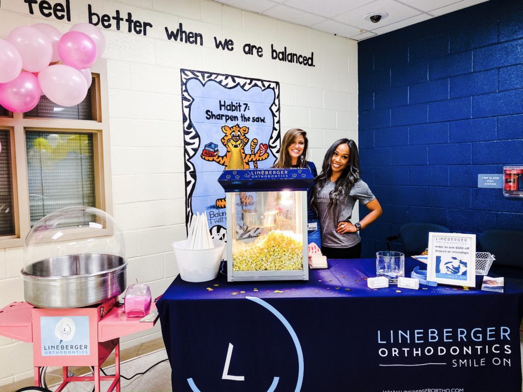 lineberger orthodontics staff giving out popcorn